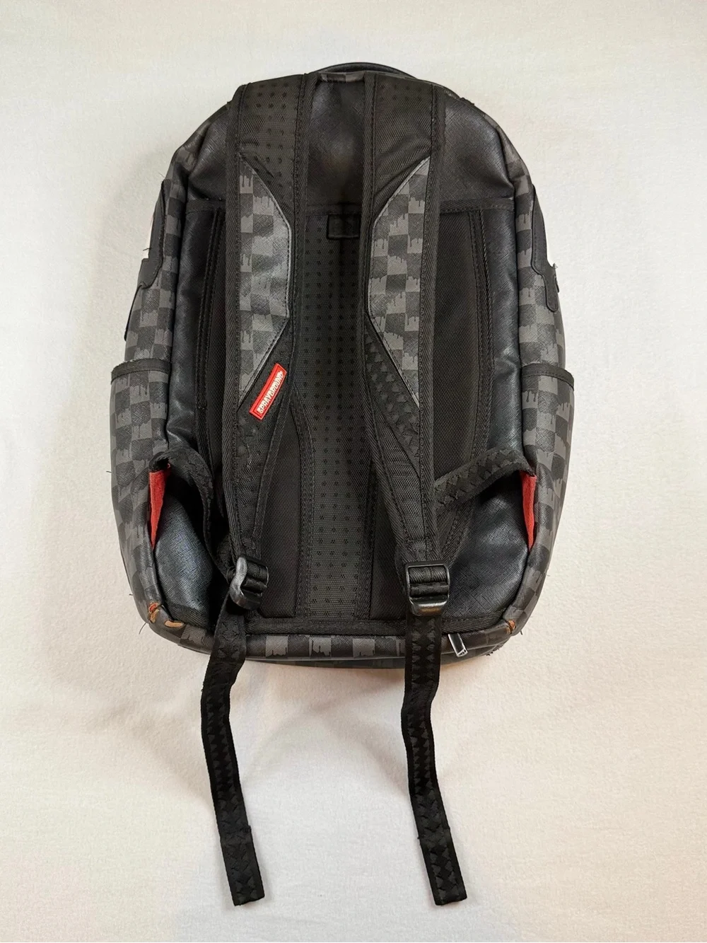 Sprayground Black Checkered Backpack with White and Red Shark Graphic